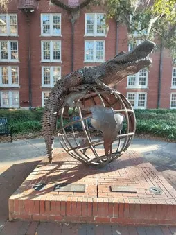 Sculpture d'un alligator posé sur un globe terrestre